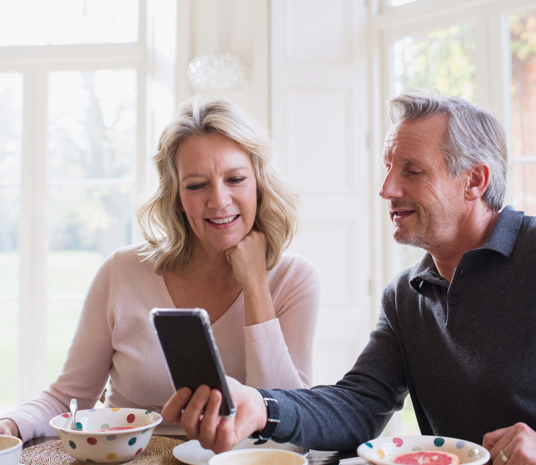 Middle-aged couple looking at a cellphone